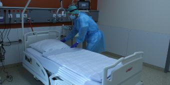 Monitor auf der Station 1c mit Pflegekraft im Isolationszimmer