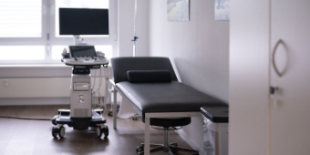 Bild: Darstellung einer Liege und eines Ultraschallgeräts im Behaldlungsraum