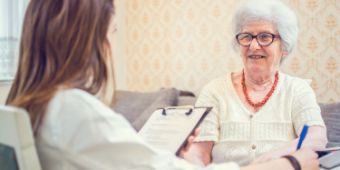 Senior woman is visited by her healthcare worker at home. 