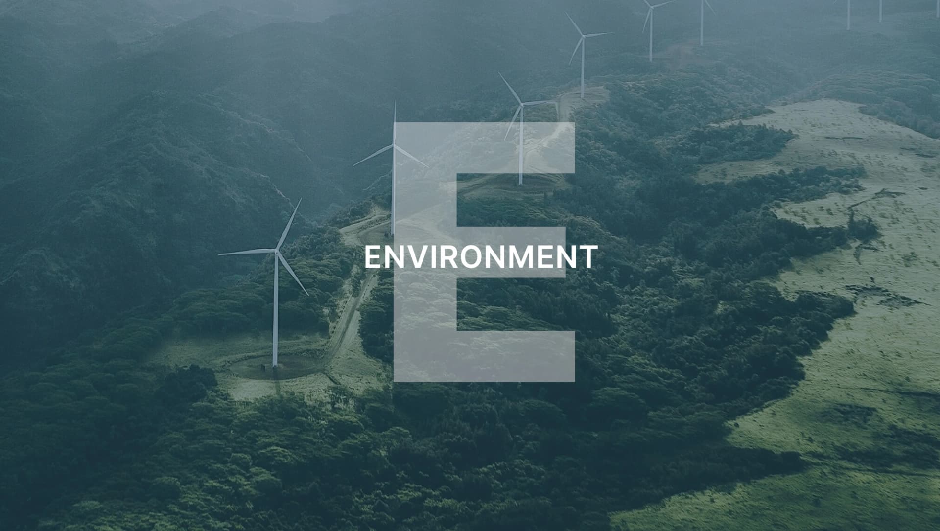Landscape with several wind turbines on wooded hills, with a large “E” and the word “ENVIRONMENT” above it.