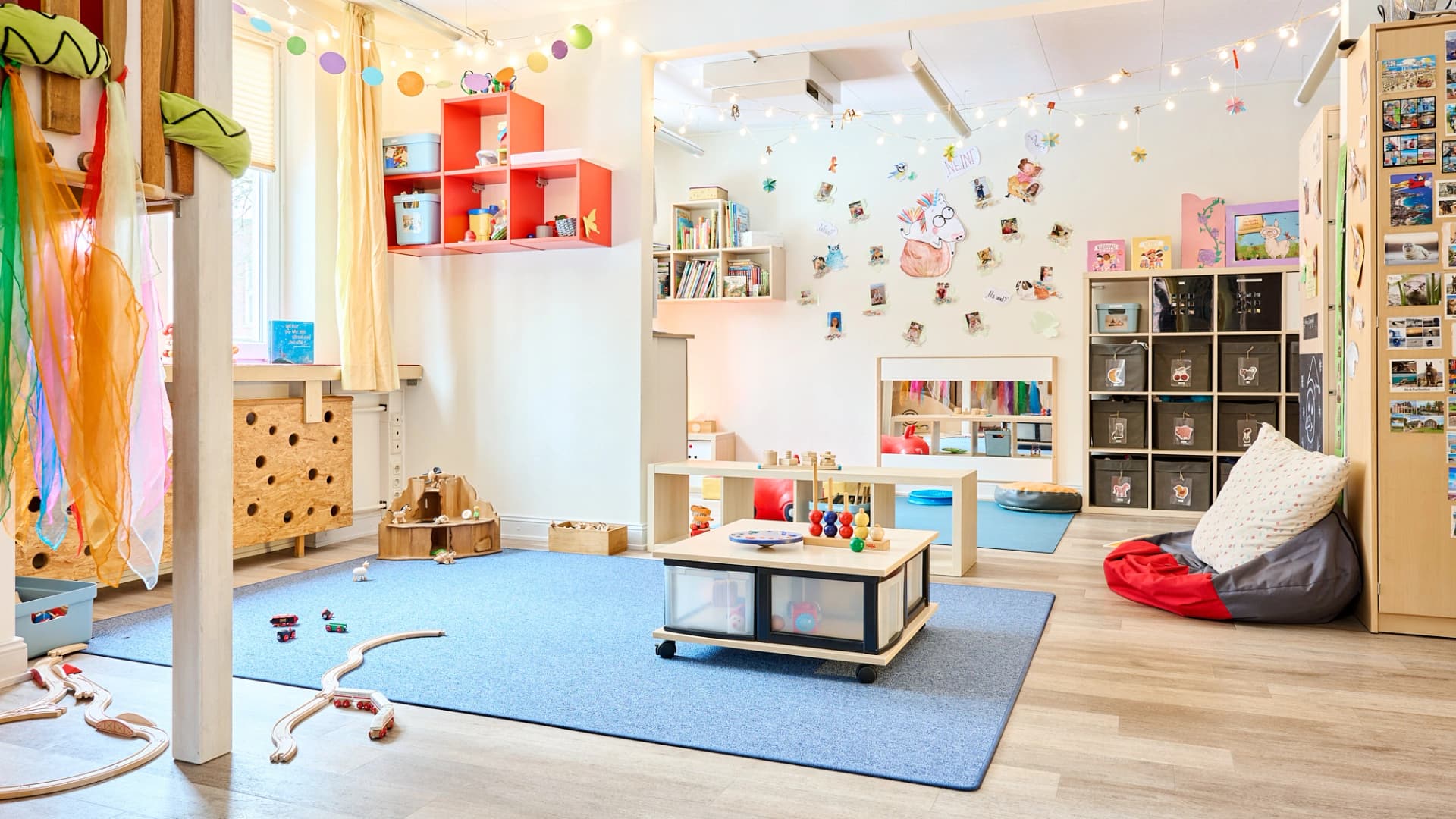 Bild: Großzügiger Gruppenraum mit Bewegungsfläche und ruhigen Spielecken für aktive und entspannte Aktivitäten