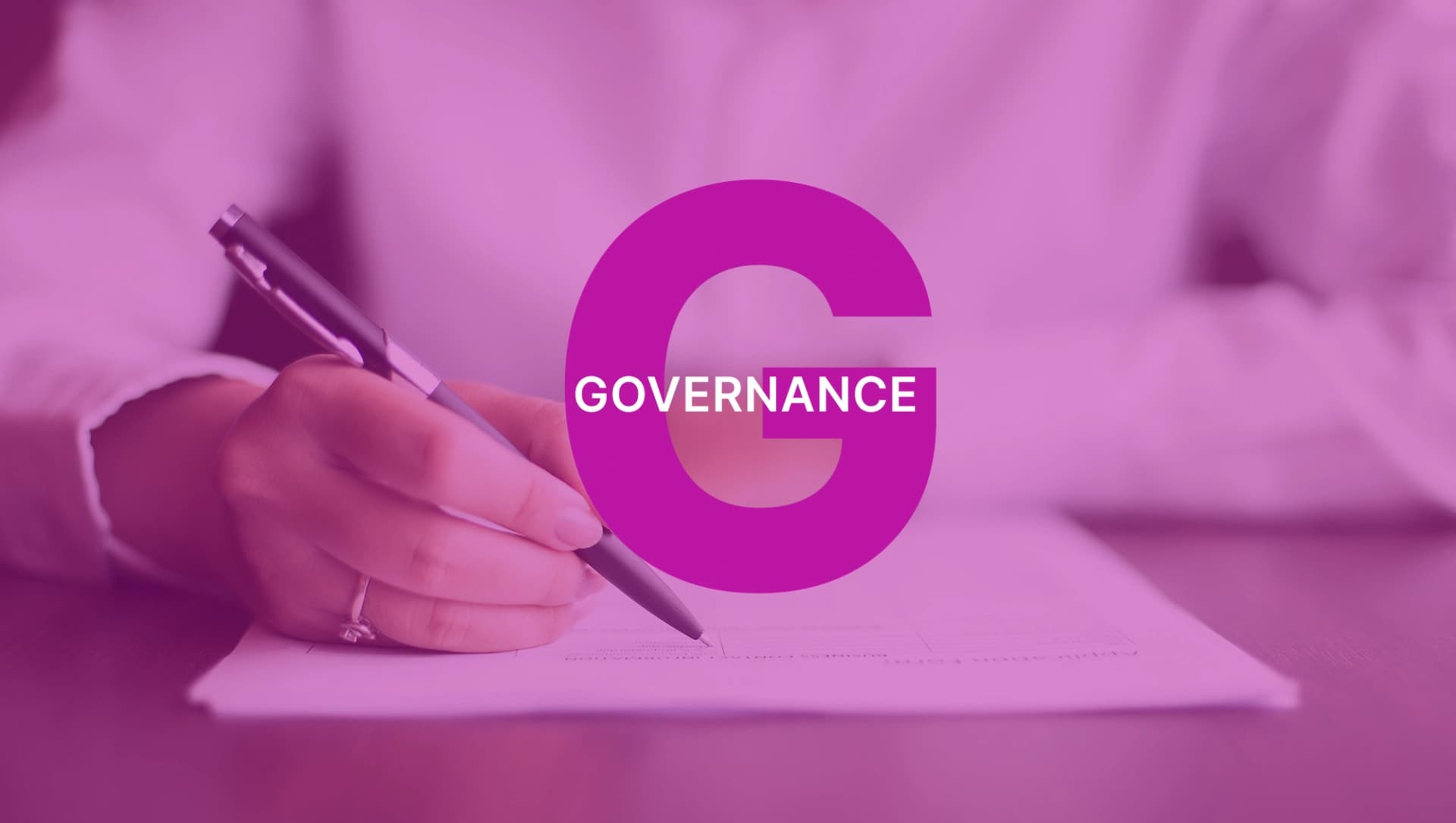 Picture: Hand of a person wearing a ring, writing on a sheet of paper with a pen, with a large “G” in dark pink and the word “GOVERNANCE” above it.