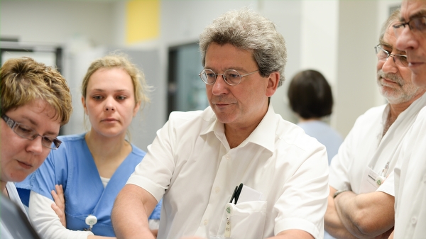 Thoraxchirurgen und Pneumologen begutachten gemeinsam mit Pflegekräften der Intensivstation Patientenunterlagen am Computer. Bild: Thoraxchirurgen und Pneumologen begutachten gemeinsam mit Pflegekräften der Intensivstation Patientenunterlagen am Computer.